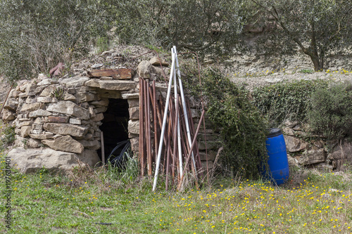 Landscape with construction for agricultural use. Stonecraft, Barraca de vinya, or caseta de pedra seca. Typical mediterranean rural structure. Monistrol de Calders,Catalonia,Spain. photo