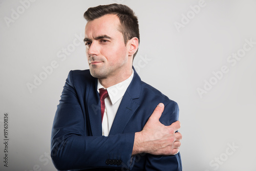 Attractive business man holding shoulder like hurting