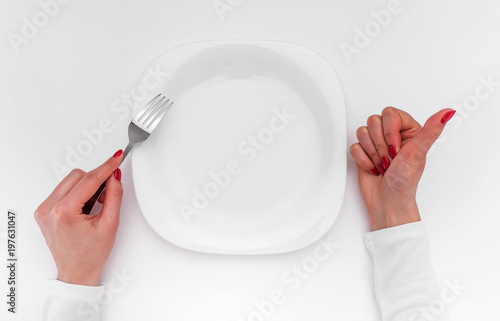 Empty plate on the table. The hand shows OK.