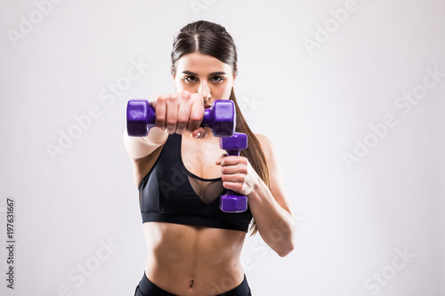 Nice young fitneess woman with dumbbells isolated on white background © F8 \ Suport Ukraine