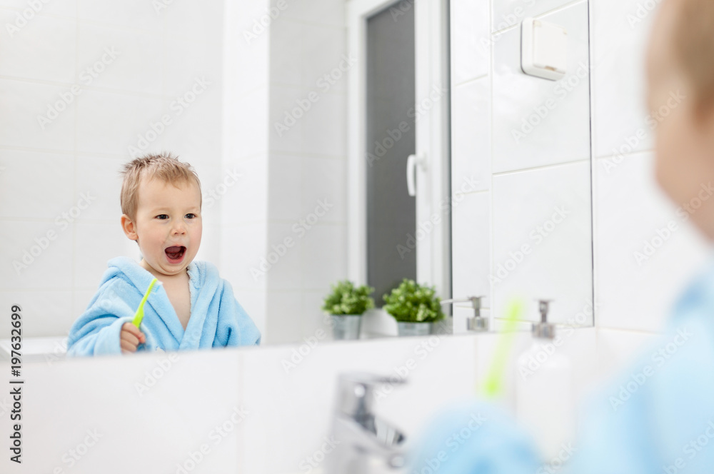 Adorable child learing how to brush his teeth Adorable child learing how to brush his teeth