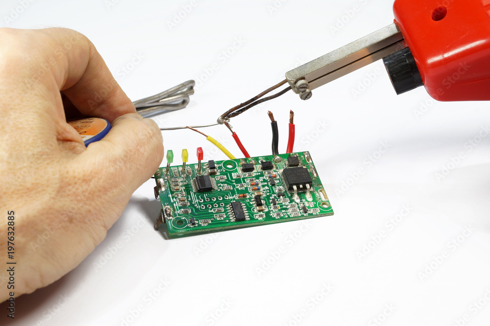 Transformer soldering iron, hand, solder. Soldering of wires on a printed circuit  board Stock Photo | Adobe Stock