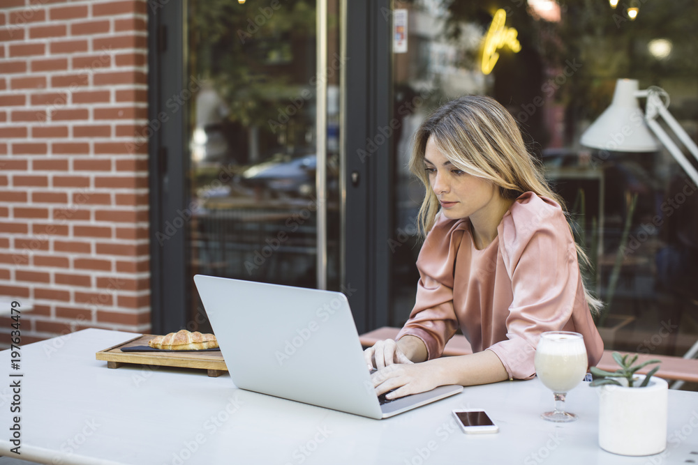 A Woman Typing on Laptop at Coffee Shop A Woman Typing on Laptop at Coffee Shop