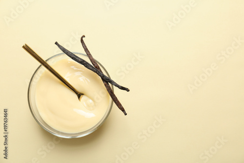 Vanilla pudding and sticks on color background