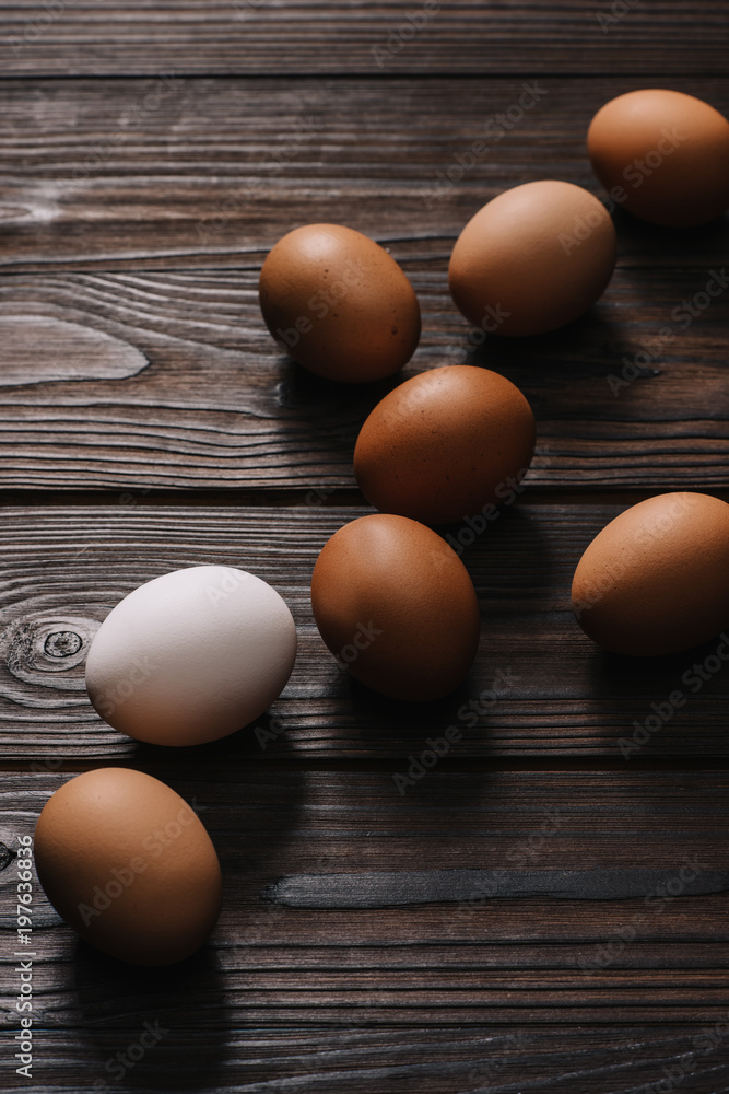 chiken eggs on wooden brown table chiken eggs on wooden brown table