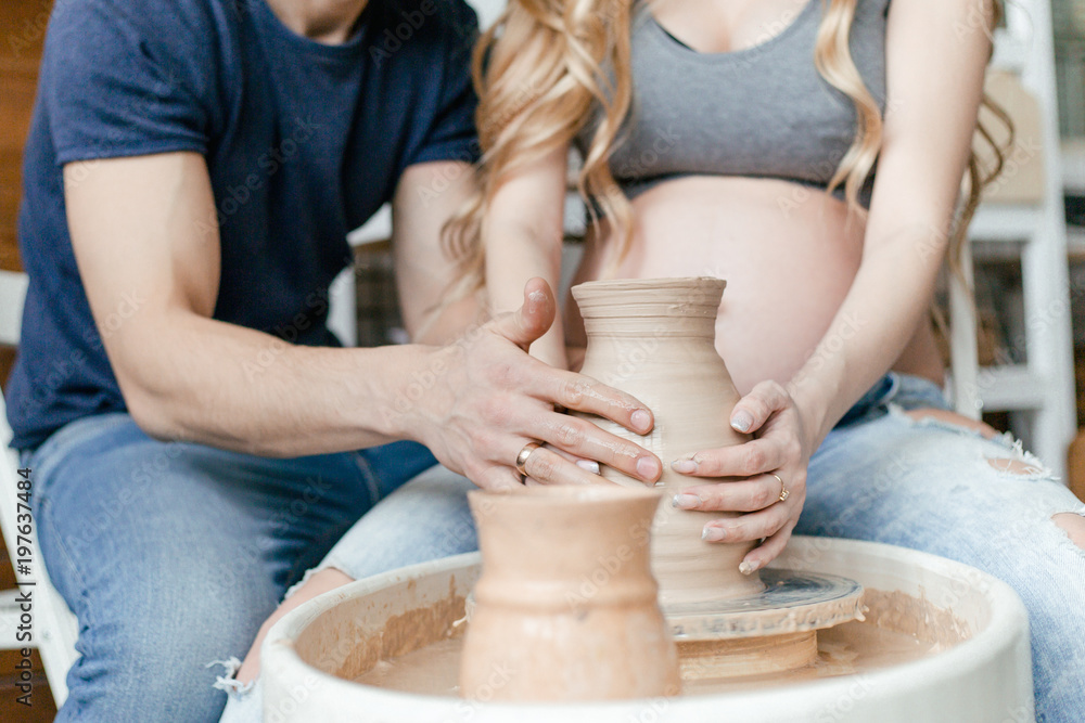 Hands together ceramics make a girl pregnant with a man close up