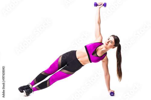 Beautiful strong woman doing fitness plank position exercises with dumbbells isolated on white