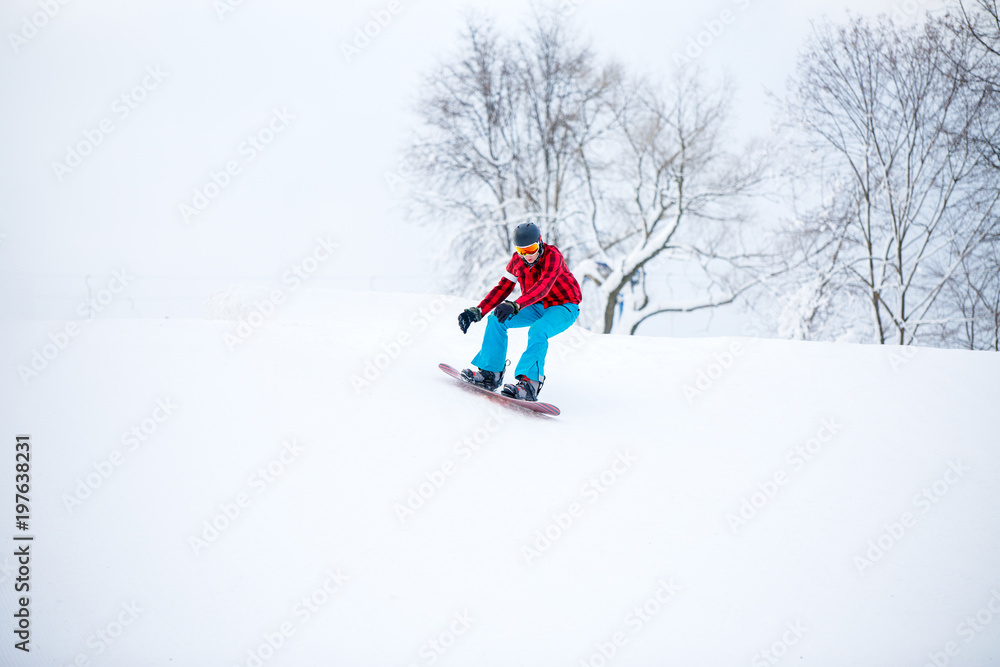 Image of snowboarder man jumping on snowy hill Image of snowboarder man jumping on snowy hill