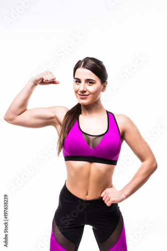 Portrait of a smiling sports woman flexing biceps and looking at camera  isolated over white background Stock Photo