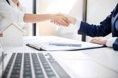 Handshake after good cooperation, Real estate broker residential agent shaking hands with customer after good deal agreement house rent listing contract