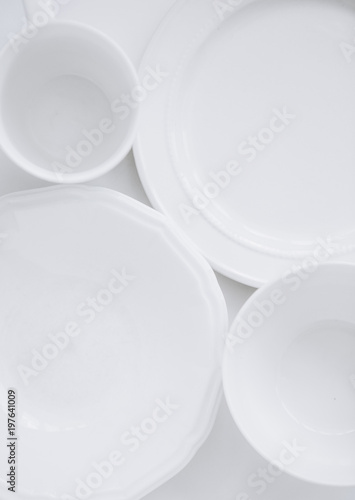 set white utensils three different plates cup white background