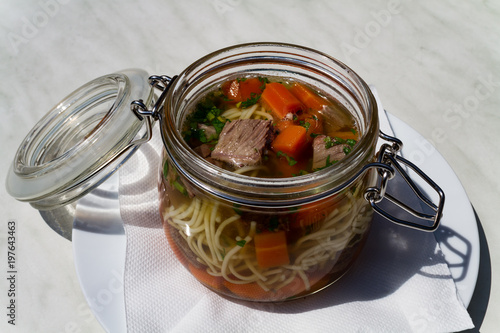 Suppe mit Nudeln mit Fleisch und Karotten im Topf als Nahaufnahme im Zoo von Schmiding photo