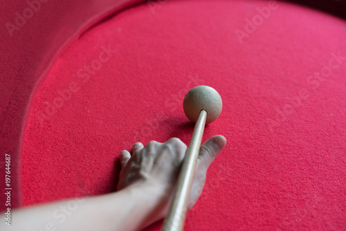 hand aiming the cue ball on billiard table.