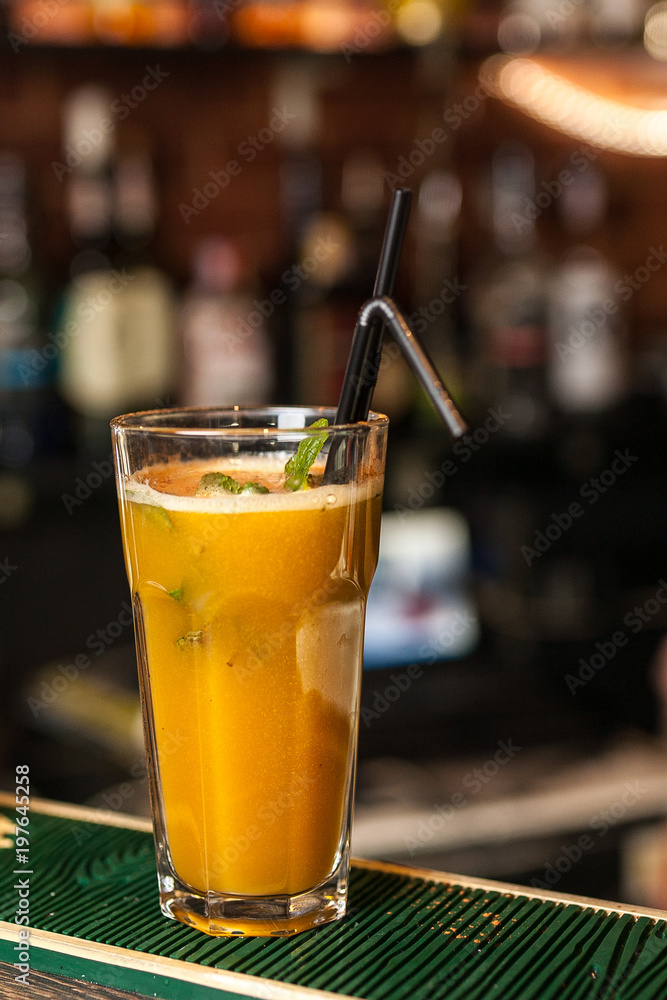 Orange cocktail with mint on the bar Orange cocktail with mint on the bar