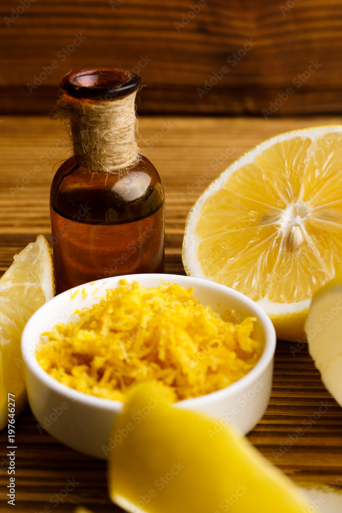 Lemon essential oil on a wooden background