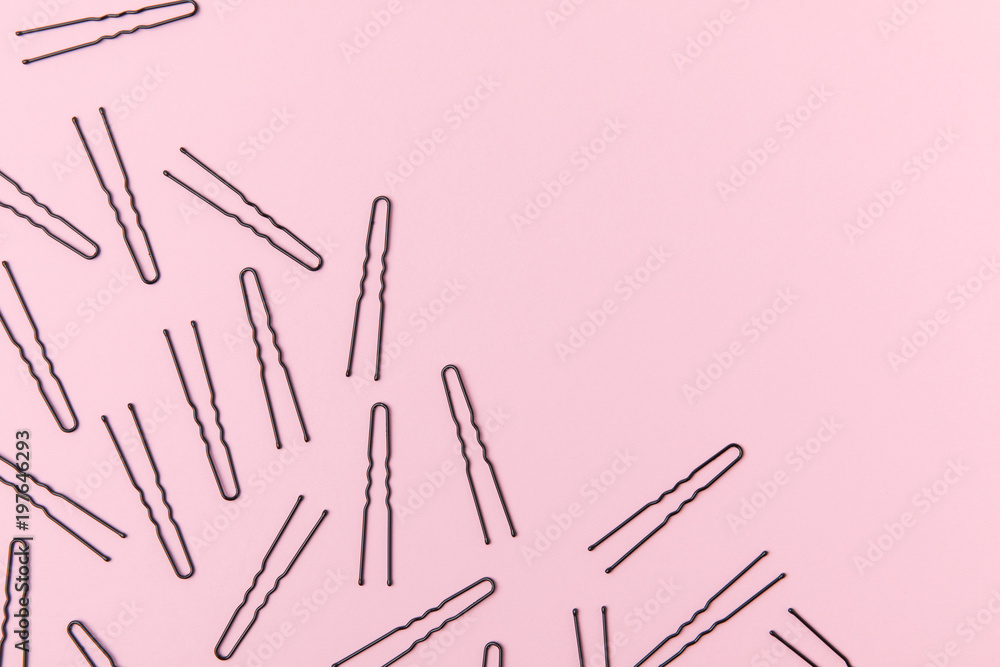 top view of black hairpins, isolated on light pink with copy space top view of black hairpins, isolated on light pink with copy space