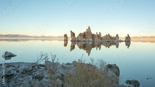 Mono lake tufas with reflection in calm water close-up on sunrise.