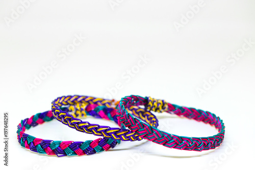 The extreme ordinary colorful bamboo wrist bands in the white background studio which made by hill tribe and can be seen in many places and no people holds the art copyright. 