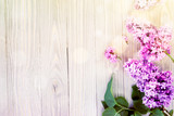 Lilac flowers on wooden table background