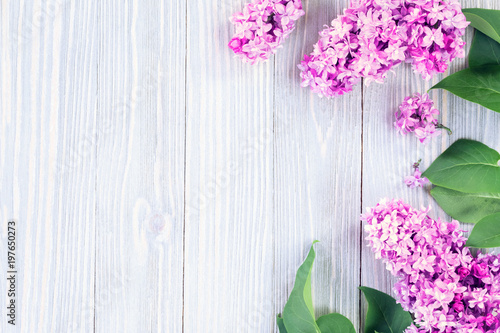 Lilac flowers on wooden table background