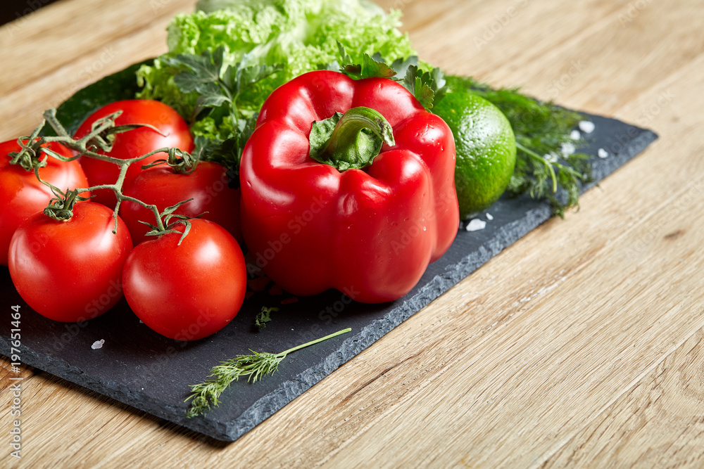 Close-up still life of assorted fresh vegetables and herbs on wooden rustic background, top view, selective focus. Close-up still life of assorted fresh vegetables and herbs on wooden rustic background, top view, selective focus.