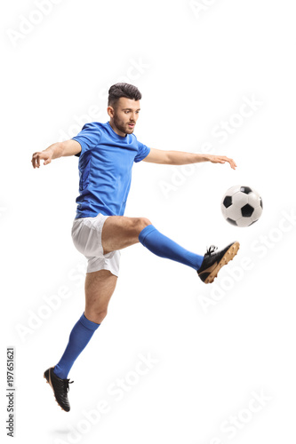 Soccer player jumping and kicking a football © Ljupco Smokovski