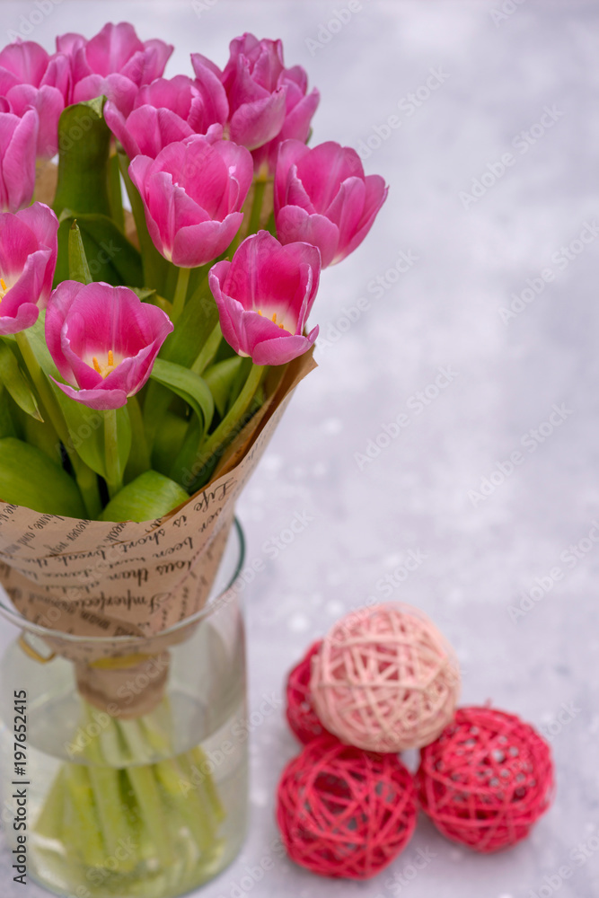 Close-up tulips in vase on gray background