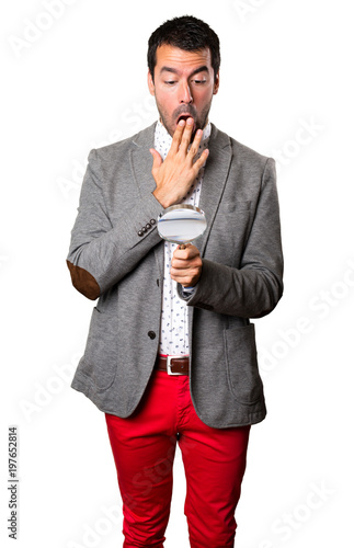 Handsome man with magnifying glass on isolated background