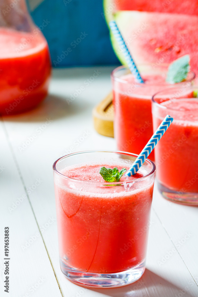 Fresh watermelon smoothies, glasses is standing on wooden table. Fresh watermelon smoothies, glasses is standing on wooden table.