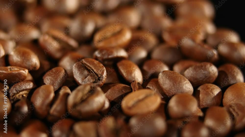 A pile of roasted coffee beans rotating. Close up A pile of roasted coffee beans rotating. Close up