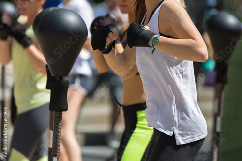 Fitness and Exercising Concept: Girls Workout with Speed Ball and Free Standing Boxing Punch Bag © GioRez