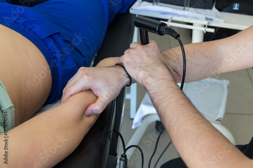 Physiotherapist doing Tecar therapy (Radio Frequency Transporter) alterantive treatment on a woman patient