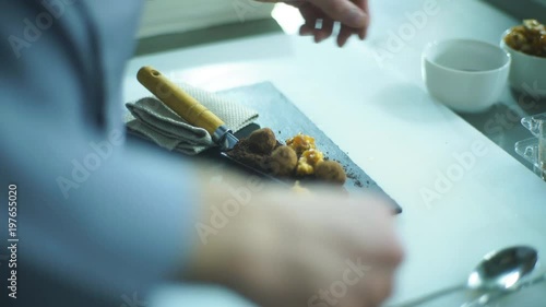 the chef decorates the dessert with truffles