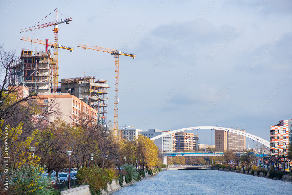 New residential and office block buildings being constructed next to river in city center of Bucharest.