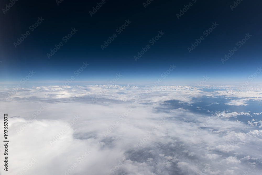 Blue sky and white clouds from window of airplane, aerial photography