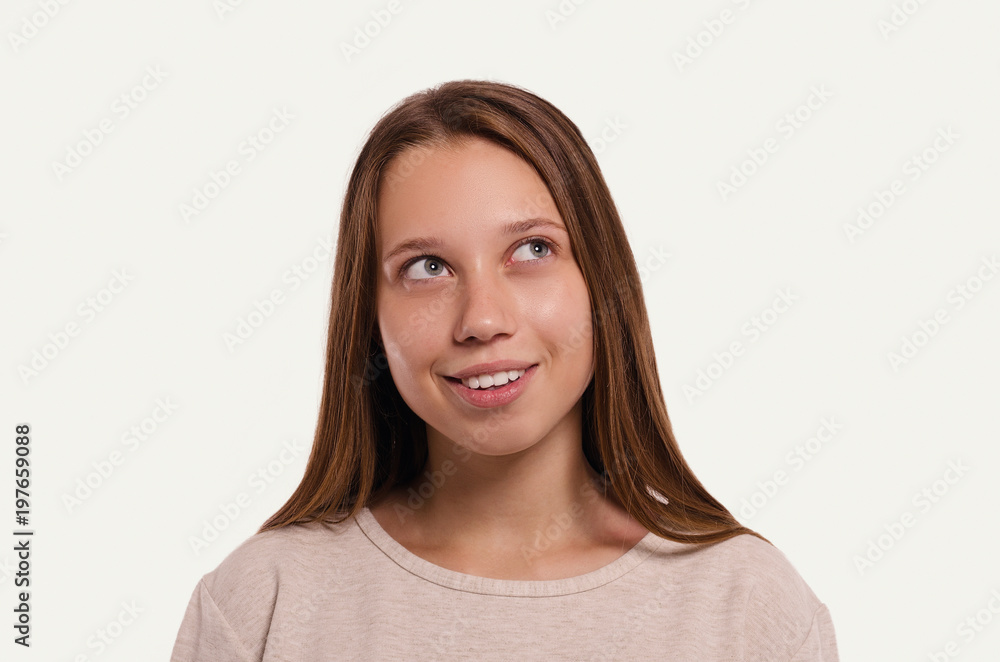 The girl has an idea. Attractive young girl portrait. Beautiful female looks away. Healthy woman studio portrait. The girl has an idea. Attractive young girl portrait. Beautiful female looks away. Healthy woman studio portrait.