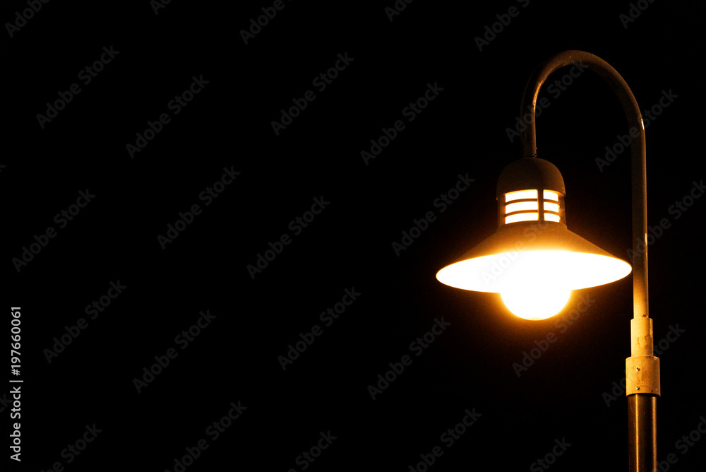A Bright lamp post emitting on a dark background A Bright lamp post emitting on a dark background
