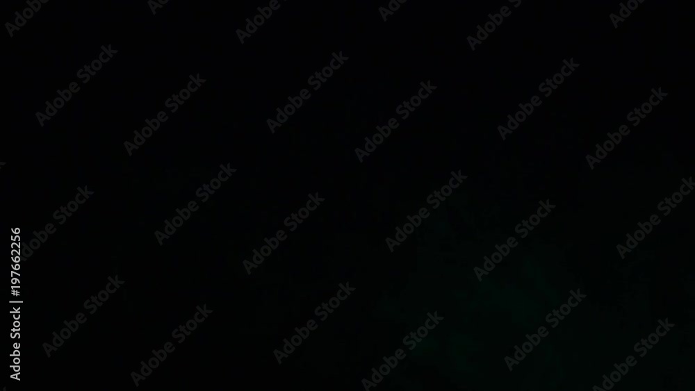 Green coloured smoke moving on black background Green coloured smoke moving on black background