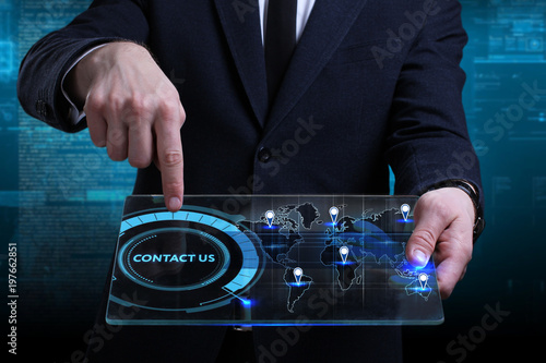 Business, Technology, Internet and network concept. Young businessman working on a virtual screen of the future and sees the inscription: Contact us
