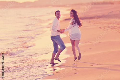 young couple on beach have fun