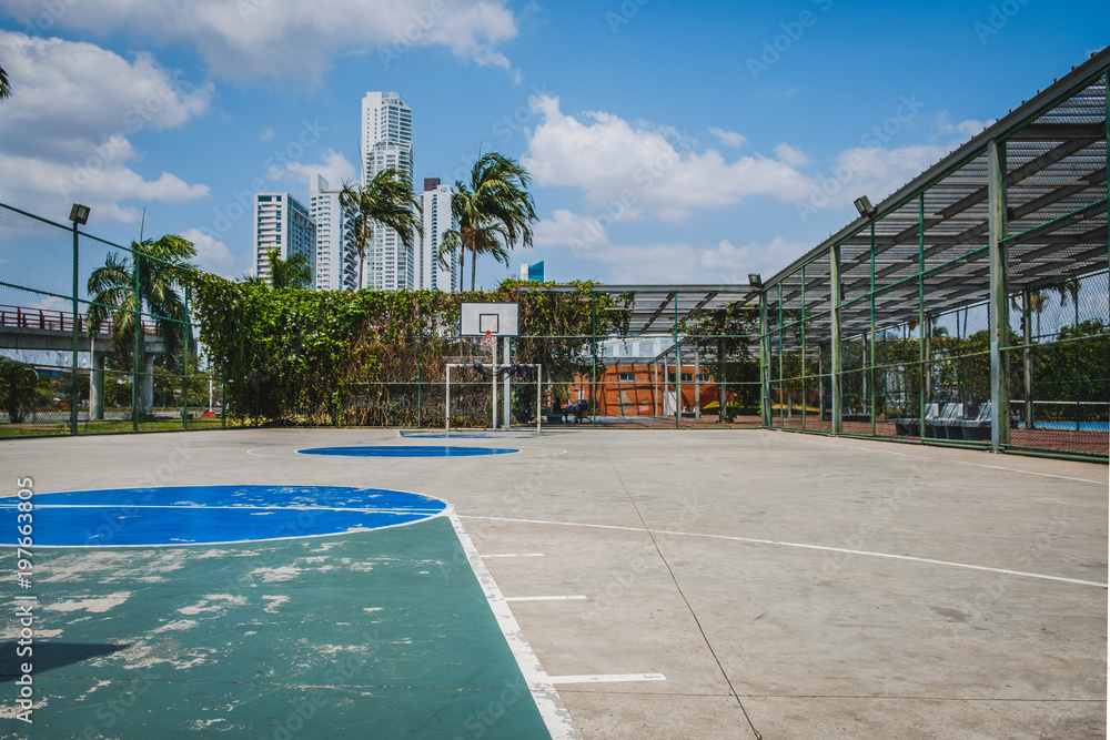 Naklejka premium basketball and soccer court outdoor with city background