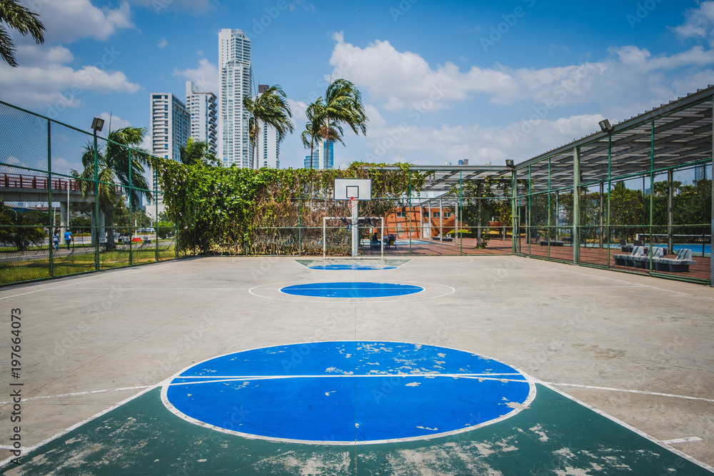 Fototapeta premium sports field, basketball court with city background