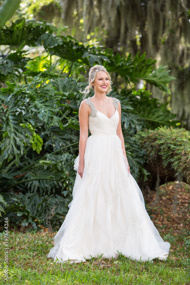 Beautiful Blonde Bride Portrait Smiling Outside in a Garden in Natural Light Beautiful Blonde Bride Portrait Smiling Outside in a Garden in Natural Light