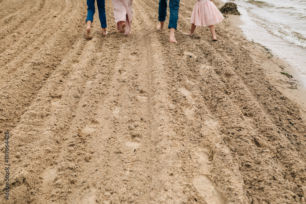Family walking along the beach Family walking along the beach