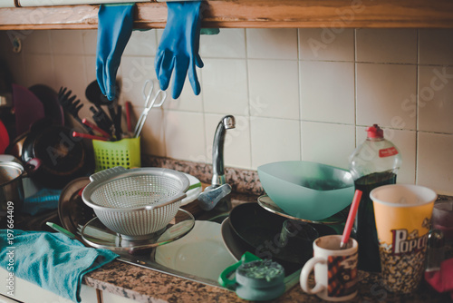 Messy countertop with dirty dishes in the sink