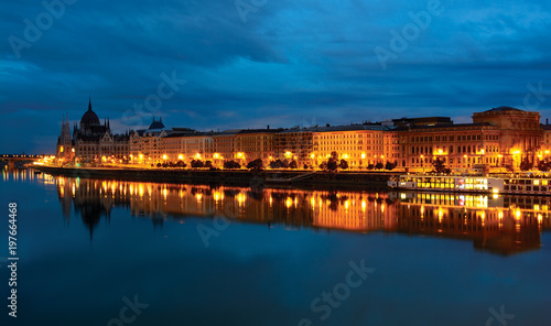Pest downtown riverfront at night  reflecting in still Danube water. Budapest  Hungary