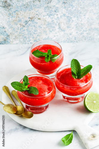 Berry Slushie with lime, Summer refreshing drink in serving glasses.