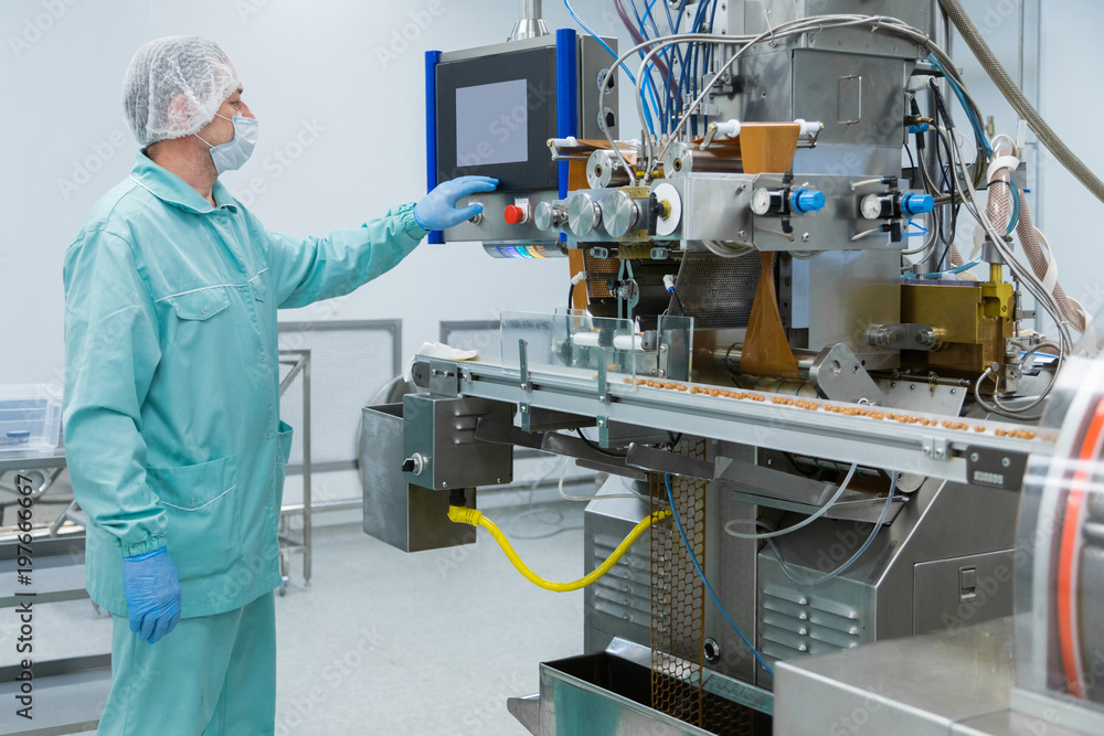 Pharmacy industry factory man worker in protective clothing in sterile working conditions Pharmacy industry factory man worker in protective clothing in sterile working conditions