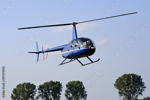 Helicopter flying in the blue sky photo