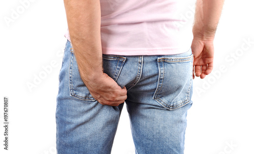  Man in jeans scratching hand his itchy bottom